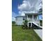 Charming single-story home with light blue siding, white trim, and a welcoming front porch at 14343 Myakka Ave, Port Charlotte, FL 33953