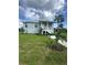Inviting home featuring a porch, new landscaping, and a healthy green lawn at 14343 Myakka Ave, Port Charlotte, FL 33953