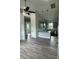 Open-concept kitchen and living area with modern gray cabinets, granite countertops, and stainless steel appliances at 14343 Myakka Ave, Port Charlotte, FL 33953