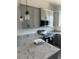 Close-up featuring modern gray cabinetry, stainless steel appliances, and granite countertops at 14343 Myakka Ave, Port Charlotte, FL 33953