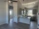 Modern kitchen features grey cabinets, granite countertops, stainless appliances, and open floorplan at 14343 Myakka Ave, Port Charlotte, FL 33953