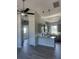 Modern kitchen features grey cabinets, granite countertops, stainless appliances, and open floorplan at 14343 Myakka Ave, Port Charlotte, FL 33953