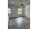 Bright living room with gray wood flooring and a ceiling fan at 14343 Myakka Ave, Port Charlotte, FL 33953