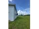 Exterior corner of home in a verdant green yard with a clear blue sky at 14343 Myakka Ave, Port Charlotte, FL 33953
