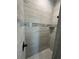 Shower featuring neutral-toned tile, mosaic accents, and a built-in shelf at 14343 Myakka Ave, Port Charlotte, FL 33953