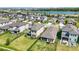 Aerial view showcasing expansive backyard, fencing, landscaping, and scenic community lake access at 16119 Paynes Mill Dr, Bradenton, FL 34211