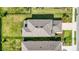 Aerial view of home displaying roof, yard, landscaping and fence line at 16119 Paynes Mill Dr, Bradenton, FL 34211