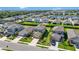 Neighborhood view showcasing modern homes with manicured lawns and proximity to community lake at 16119 Paynes Mill Dr, Bradenton, FL 34211
