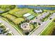 Stunning aerial view of community amenities including pool, sports fields, playground, and parking at 16119 Paynes Mill Dr, Bradenton, FL 34211