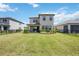 Spacious backyard featuring a well-maintained lawn, established landscaping, and a cozy patio at 16119 Paynes Mill Dr, Bradenton, FL 34211