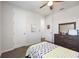 Bright bedroom featuring a window, soft carpet, neutral walls, and a ceiling fan at 16119 Paynes Mill Dr, Bradenton, FL 34211