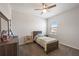 Bright bedroom featuring a window, soft carpet, neutral walls, and a ceiling fan at 16119 Paynes Mill Dr, Bradenton, FL 34211