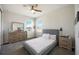 Bright bedroom features a large window, soft carpet, neutral walls, and a ceiling fan at 16119 Paynes Mill Dr, Bradenton, FL 34211