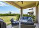Covered patio featuring comfortable seating and view of the backyard at 16119 Paynes Mill Dr, Bradenton, FL 34211