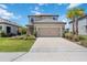 Two-story home with a two-car garage and a well-maintained lawn, creating a picturesque curb appeal at 16119 Paynes Mill Dr, Bradenton, FL 34211