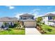 Beautiful two-story home with a well-manicured lawn and attractive landscaping at 16119 Paynes Mill Dr, Bradenton, FL 34211