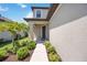 Inviting front entrance with verdant landscaping and a stylish front door, creating a warm welcome at 16119 Paynes Mill Dr, Bradenton, FL 34211