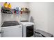 Functional laundry room with a washer, dryer, and practical shelving at 16119 Paynes Mill Dr, Bradenton, FL 34211