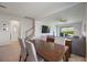 Open floor plan with living, dining, and staircase, flowing to the backyard through sliding glass doors at 16119 Paynes Mill Dr, Bradenton, FL 34211