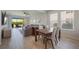 Open-concept space showcasing living and dining areas, large windows, and seamless access to the backyard at 16119 Paynes Mill Dr, Bradenton, FL 34211