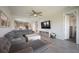 Inviting living room features a ceiling fan, sectional sofa, large TV, and view of the kitchen at 16119 Paynes Mill Dr, Bradenton, FL 34211