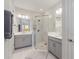 Stylish bathroom with double sinks, modern lighting, and a frameless glass shower at 16119 Paynes Mill Dr, Bradenton, FL 34211