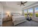 Bright main bedroom with large bed, bedside tables, ceiling fan and plenty of natural light at 16119 Paynes Mill Dr, Bradenton, FL 34211