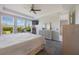 Bright main bedroom featuring a ceiling fan, large windows and plush carpet at 16119 Paynes Mill Dr, Bradenton, FL 34211