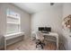 Bright office space featuring a modern desk, two monitors, and wood-look tile flooring at 16119 Paynes Mill Dr, Bradenton, FL 34211
