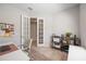 Office with french doors, wood-look tile flooring, and shelving at 16119 Paynes Mill Dr, Bradenton, FL 34211