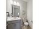 Charming powder room with a modern vanity, light fixture, and tiled floors at 16119 Paynes Mill Dr, Bradenton, FL 34211