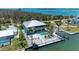 An aerial view showcases this coastal property's pool, dock, waterfront access, and lush tropical foliage at 1918 Massachusetts Ave, Englewood, FL 34224