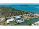 An aerial view shows the home's close proximity to open waters, lush landscaping, and coastal location at 1918 Massachusetts Ave, Englewood, FL 34224