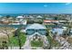 An aerial view of this lovely, two-story waterway home shows mature landscaping and coastal views at 1918 Massachusetts Ave, Englewood, FL 34224