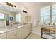 The bathroom features double sinks, plantation shutters, and decorative accents at 1918 Massachusetts Ave, Englewood, FL 34224