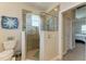 Tiled bathroom with glass shower, toilet, and nautical decor at 1918 Massachusetts Ave, Englewood, FL 34224