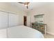 Bedroom with ceiling fan, dresser with mirror and spacious closet at 1918 Massachusetts Ave, Englewood, FL 34224