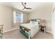 This bedroom features coastal decor, a comfortable bed, and a ceiling fan at 1918 Massachusetts Ave, Englewood, FL 34224