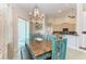 Dining room with unique wooden table and chairs, and a stylish chandelier at 1918 Massachusetts Ave, Englewood, FL 34224