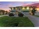Charming coastal home with dual staircase, manicured lawn, and lush tropical landscaping at 1918 Massachusetts Ave, Englewood, FL 34224