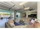 Open garage featuring seating area and access to the lanai, offering versatile indoor-outdoor living and parking at 1918 Massachusetts Ave, Englewood, FL 34224