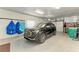 Well-lit garage with a black SUV, epoxy floors, and ample storage space, providing convenience and functionality at 1918 Massachusetts Ave, Englewood, FL 34224