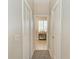 Hallway provides access to the bathroom with view to a console table at 1918 Massachusetts Ave, Englewood, FL 34224