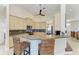 Kitchen with breakfast bar and a view into the dining room at 1918 Massachusetts Ave, Englewood, FL 34224