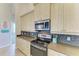 Well-equipped kitchen with updated stainless steel appliances and sleek countertops at 1918 Massachusetts Ave, Englewood, FL 34224