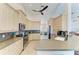 Spacious kitchen with light wood cabinets, stainless steel appliances, and a mosaic backsplash at 1918 Massachusetts Ave, Englewood, FL 34224