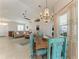 Bright living room with tile floors, area rug, comfortable seating, and a decorative chandelier at 1918 Massachusetts Ave, Englewood, FL 34224