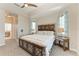 Serene main bedroom featuring carpet, tray ceilings, a decorative headboard, and soft lighting at 1918 Massachusetts Ave, Englewood, FL 34224