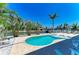 Scenic pool area featuring a sparkling pool, waterfront views, and ample lounging space for outdoor enjoyment at 1918 Massachusetts Ave, Englewood, FL 34224