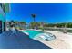 Inviting backyard pool with in-pool loungers, surrounded by lush landscaping and tranquil water views at 1918 Massachusetts Ave, Englewood, FL 34224